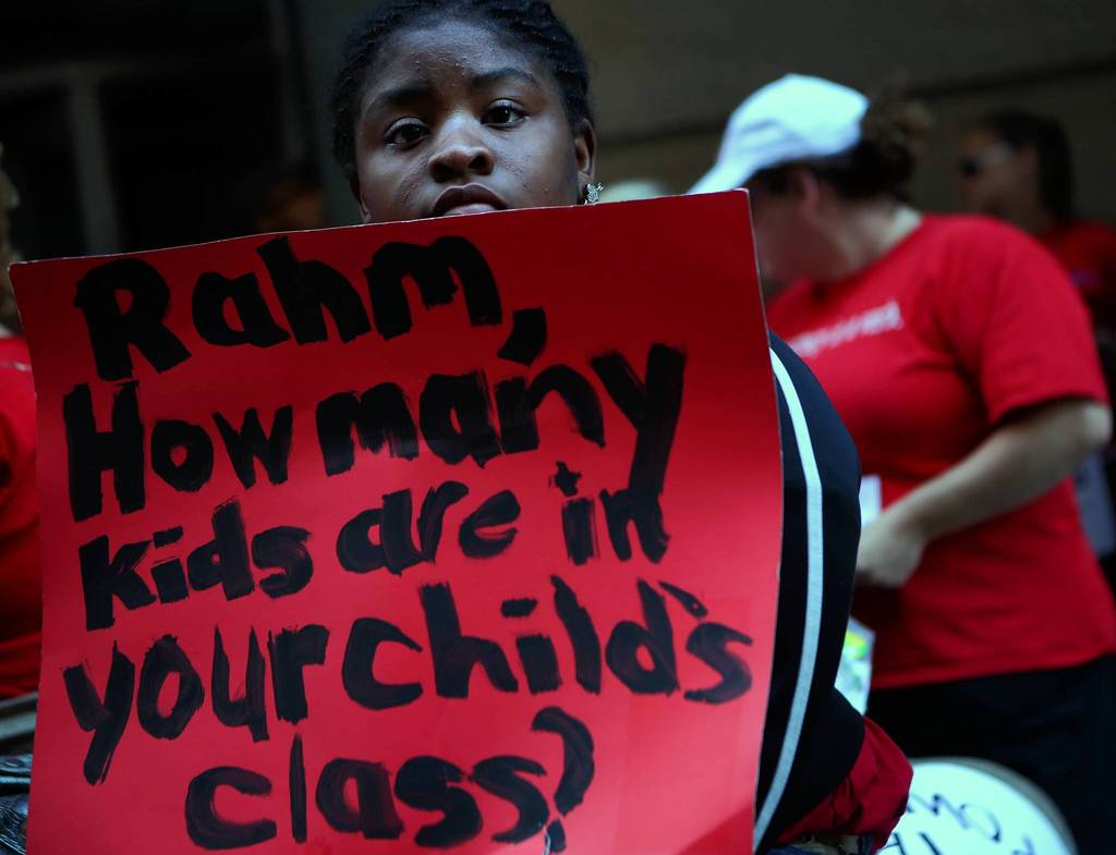A supporter of the Chicago Teachers Union strike holds a sign outside Chicago Public Schools headquarters.