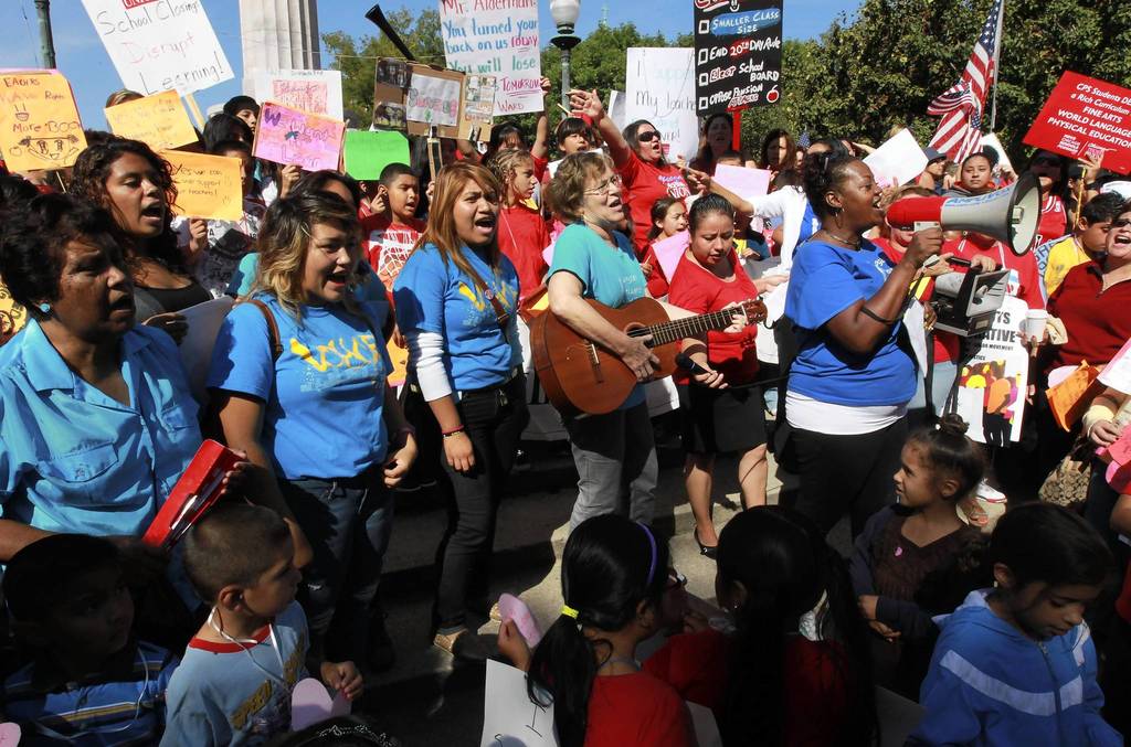 Hundreds of CPS teachers, students and their supporters rally, sing songs and speak out in support for teachers at the Logan Square monument.