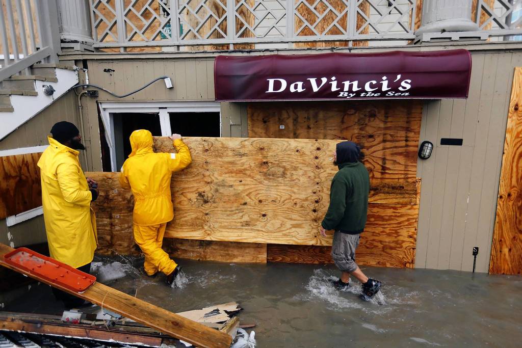 An oceanfront restaurant is boarded up after waves crashed over the boardwalk in Ocean City, Maryland, while Hurricane Sandy intensifies. About 50 million people from the Mid-Atlantic to Canada were in the path of the nearly 1,000-mile-wide (1,600-km-wide) storm, which forecasters said could be the largest to hit the mainland in U.S. history.