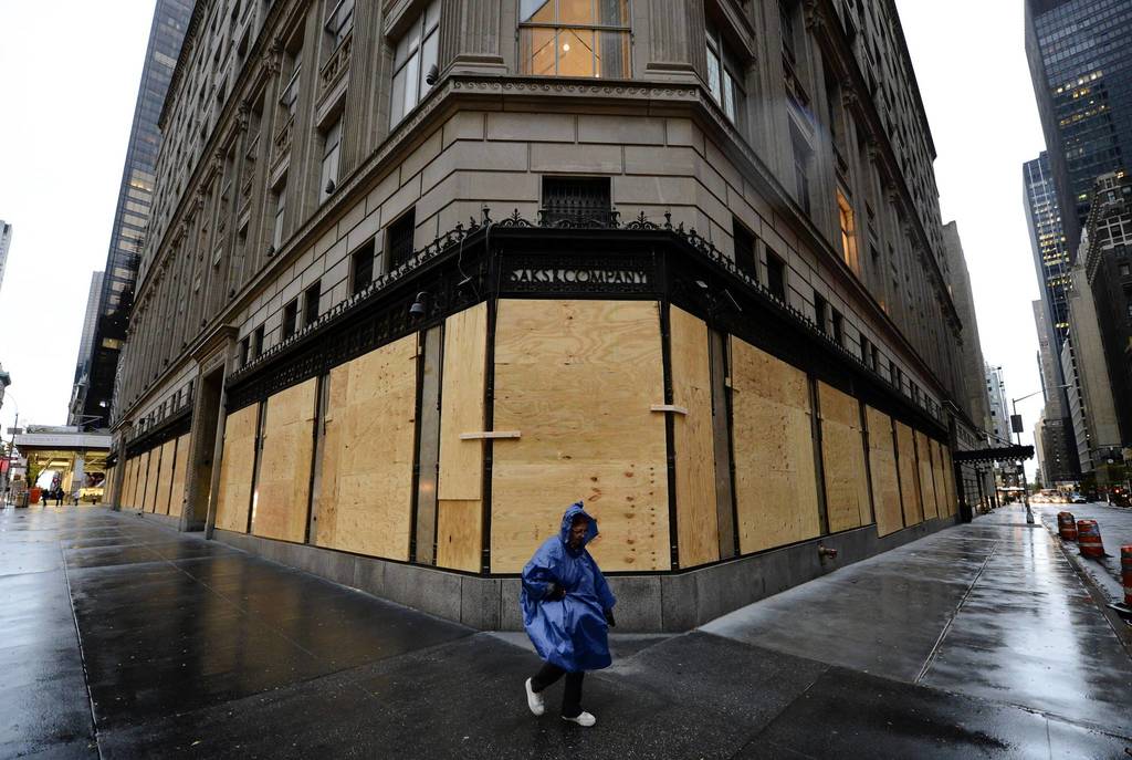 A woman walks past a boarded up Saks Fifth Avenue as New Yorkers prepare for Hurricane Sandy which is suppose to hit the city later tonight. Much of the eastern United States was in lockdown mode, awaiting the arrival of a hurricane dubbed 