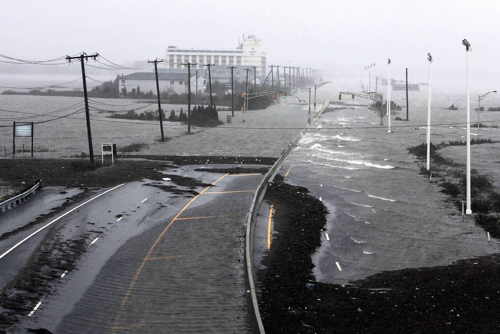 U.S. Route 30, the White Horse Pike, one of three major approaches to Atlantic City, New Jersey, is covered with water from Absecon Bay in this view looking west, during the approach of Hurricane Sandy. Hurricane Sandy began battering the U.S. East Coast on Monday with fierce winds and driving rain, as the monster storm shut down transportation, shuttered businesses and sent thousands scrambling for higher ground hours before the worst was due to strike.