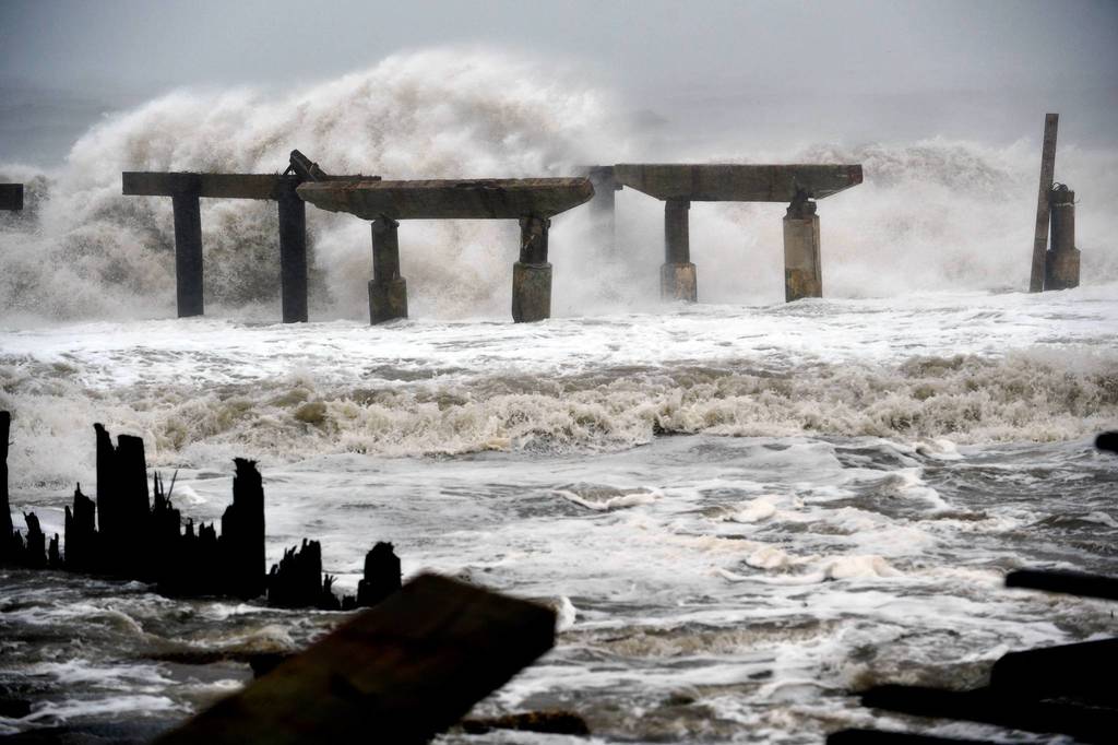 Waves crash against a previously damaged pier before landfall of Hurricane Sandy in Atlantic City, New Jersey. Storm-driven waves crashed ashore and flooded seafront communities across a swathe of the eastern United States as Hurricane Sandy barreled towards land. Officials warned that the threat to life and property was 