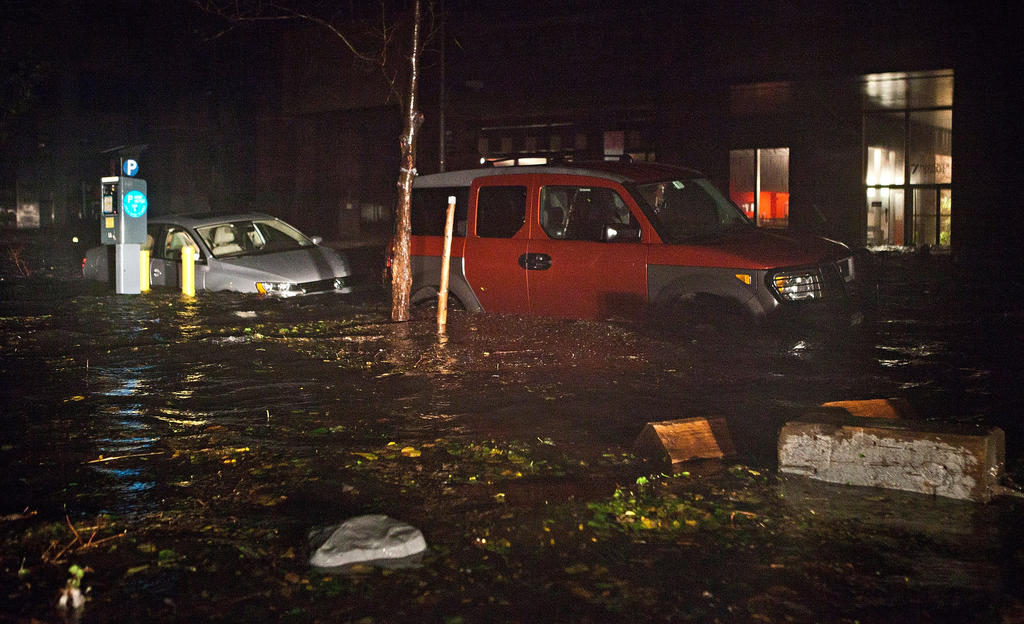Floodwater covers cars in the Financial District of New York Monday night.