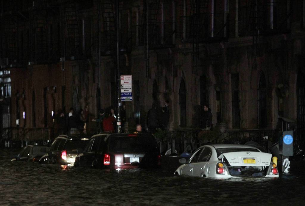 Flood waters brought on by Hurricane Sandy over run cars in New York's lower east side. Hurricane Sandy began battering the U.S. East Coast on Monday with fierce winds and driving rain, as the monster storm shut down transportation, shuttered businesses and sent thousands scrambling for higher ground hours before the worst was due to strike.