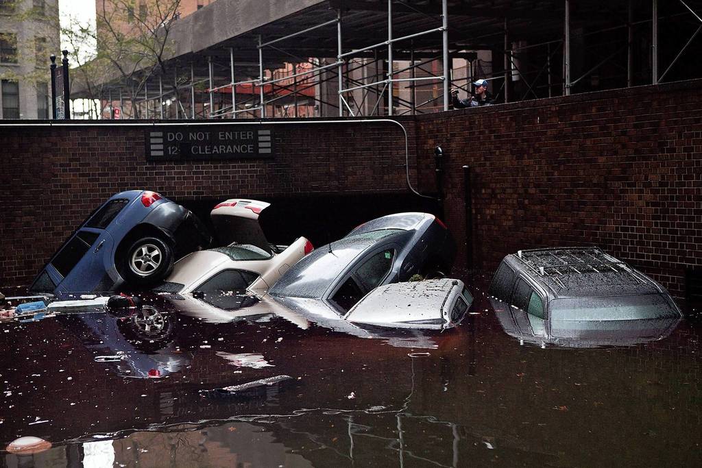 Cars float outside a flooded parking garage following Hurricane Sandy's hit in the Financial District of New York. The storm has claimed at least 16 lives and caused massive flooding across much of the Atlantic seaboard. President Barack Obama has declared the situation a 'major disaster' for large areas of the U.S. East Coast, including New York City.