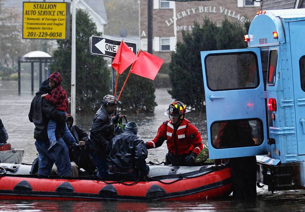 Residents are rescued by emergency personnel from flood waters brought on by Hurricane Sandy in Little Ferry, New Jersey. Millions of people across the eastern United States awoke on Tuesday to scenes of destruction wrought by monster storm Sandy, which knocked out power to huge swathes of the nation's most densely populated region, swamped New York's subway system and submerged streets in Manhattan's financial district.