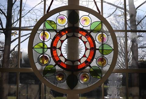 A stained glass window, created by Chicago-based artist David Lee Csicsko, is on display at the East Wing during a preview of the 2012 White House holiday decorations, in Washington, DC.