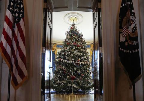 The official White House Christmas tree, an 18-foot-6-inch Fraser Fir from Jefferson, North Carolina, stands in the Blue Room during a preview of the 2012 White House holiday decorations in Washington, DC.
