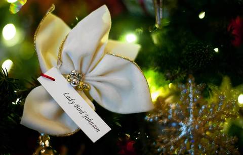 Former first fady Lady Bird Johnson's ornament adorns a first lady Chirstmas tree in the Grand Foyer that holds White House ornaments from Christmases past, during the first viewing of the White House 2012 holiday decorations in Washington, DC.
