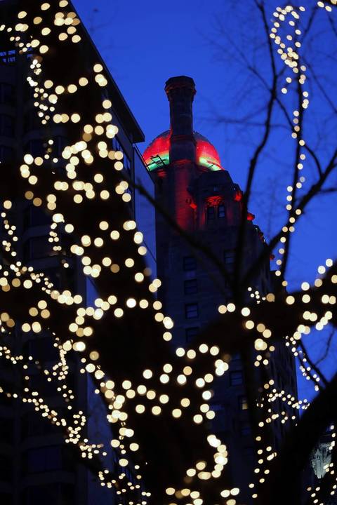 The top of the Hotel Intercontinental is illuminated in Christmas colors.