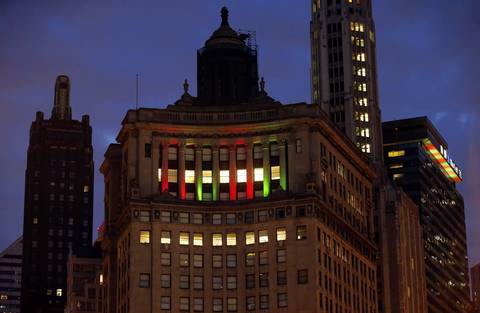 Columns on the London Guarantee Building, near the south end of the Michigan Avenue Bridge, are illuminated with Christmas color lights.