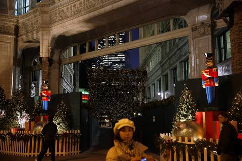 People stroll past a holiday display in front of the Wrigley Building, on Michigan Avenue in downtown Chicago.