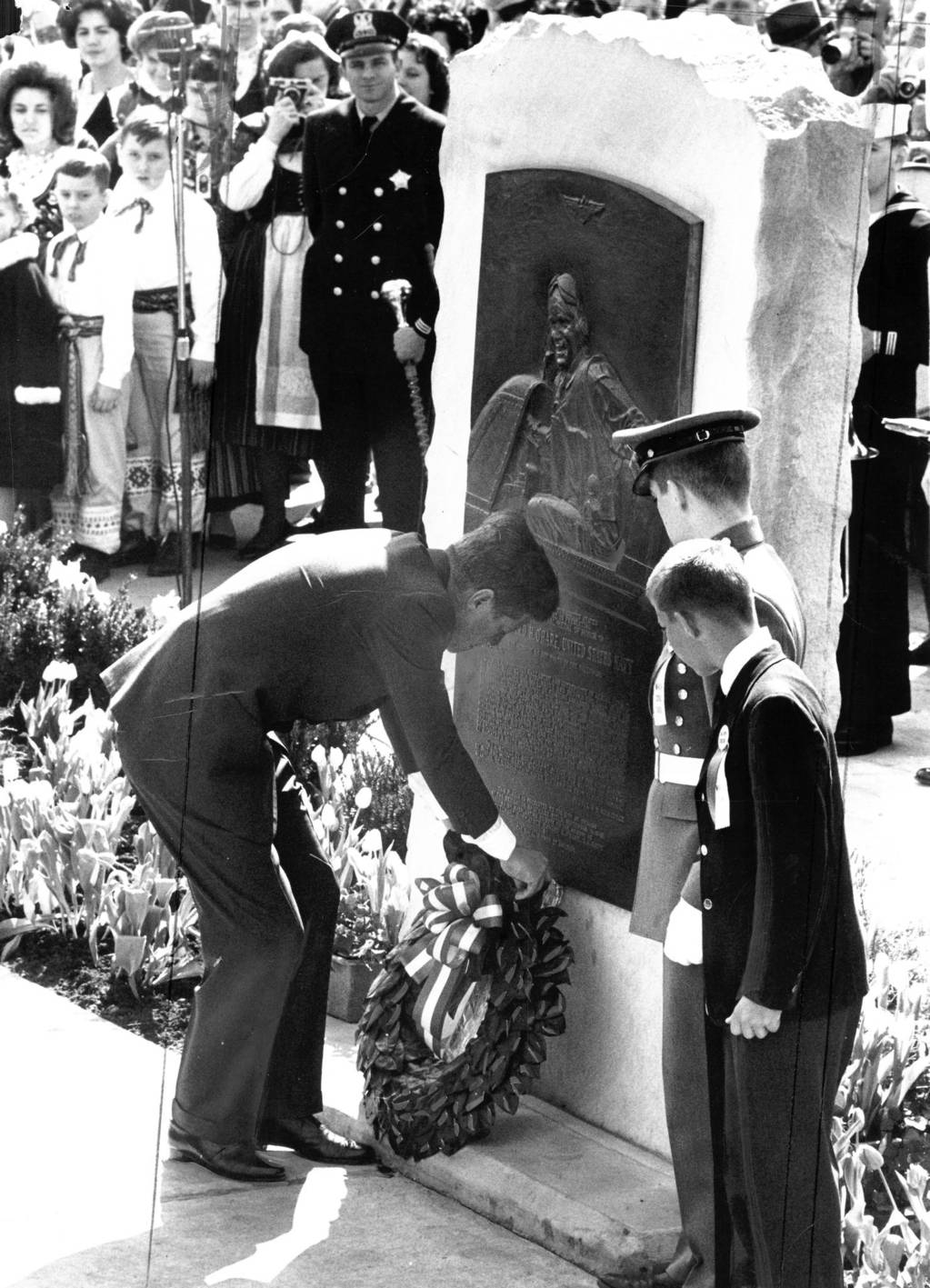 In 1963 President Kennedy lays a wreath on a monument dedicated to Lt. Comdr. Edward 