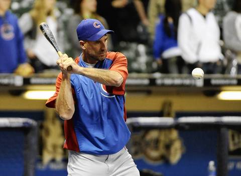 Cubs manager Dale Sveum hits grounders during warmups