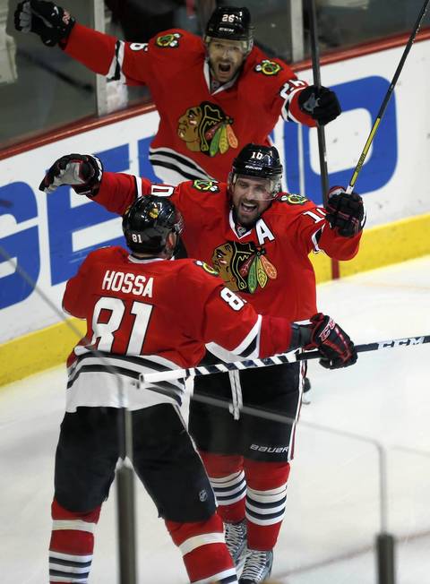 Patrick Sharp celebrates his second period goal with Marian Hossa and Michal Handzus.