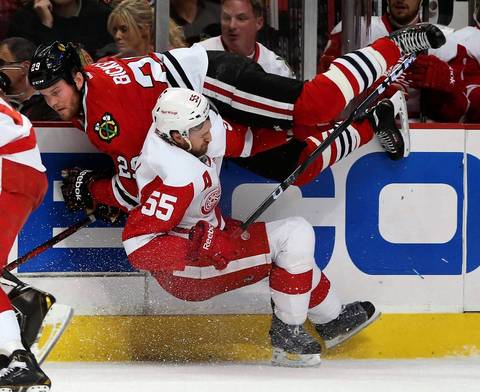 Bryan Bickell and the Red Wings' Niklas Kronwall collide along the boards in the first period.