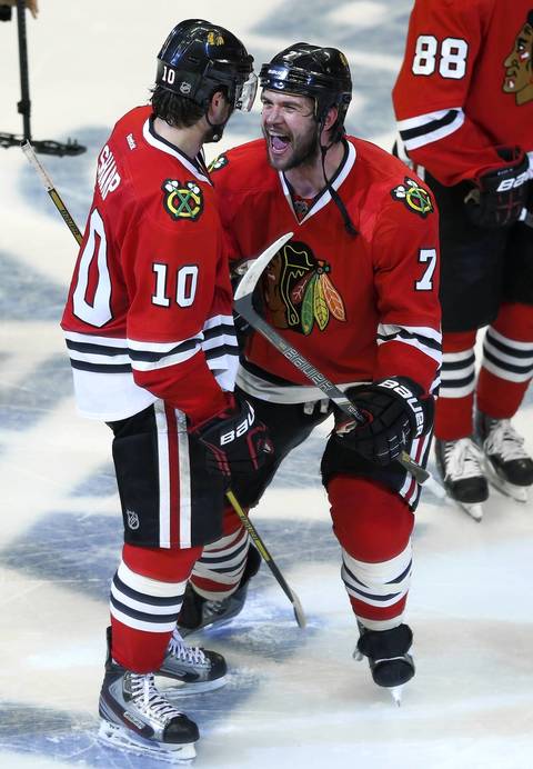 Brent Seabrook and Patrick Sharp celebrate Seabrook's game-winning overtime goal.