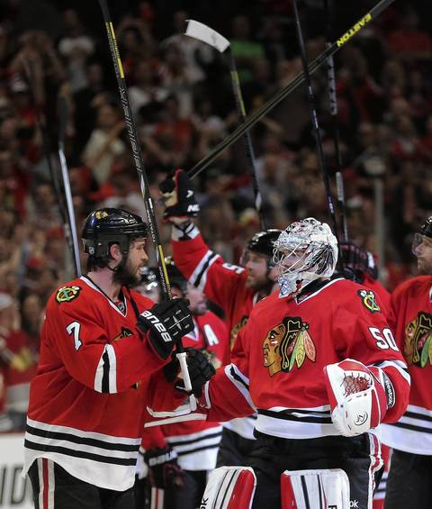 Brent Seabrook and goalie Corey Crawford celebrate after winning Game 7.