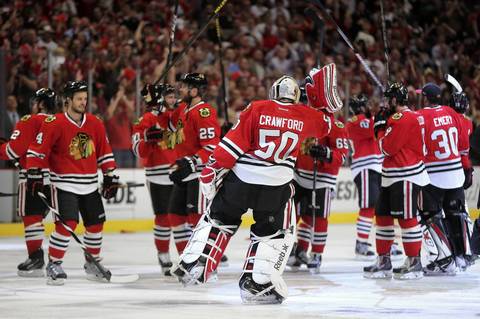 Blackhawks goalie Corey Crawford celebrates with his team after beating the Red Wings in Game 7.