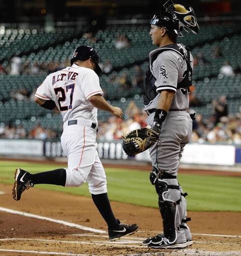Jose Altuve of the Houston Astros scores on a double by Jason Castro in the first.