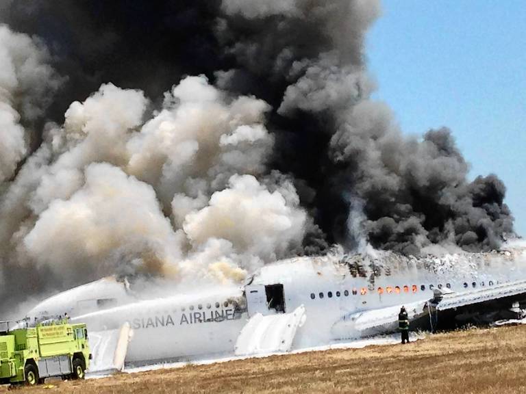 Asiana Airlines Boeing 777 is fully engulfed on the tarmac after crash landing at San Francisco International Airport.