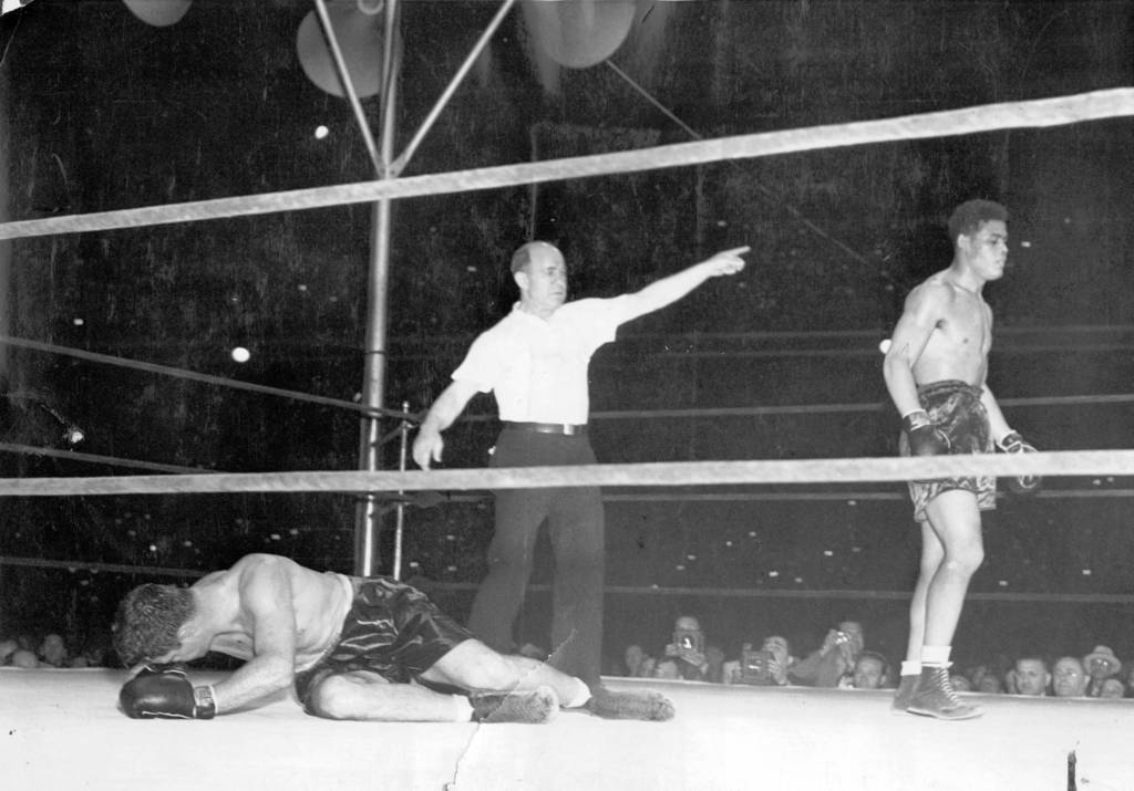 Referee Tommy Thomas counts Jim Braddock out in the eighth round of the Comiskey Park fight in which Joe Louis hammered his way to the heavyweight championship on June 22, 1937.