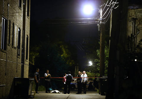 Chicago Police stand at the scene of a fatal shooting near Madison St ...