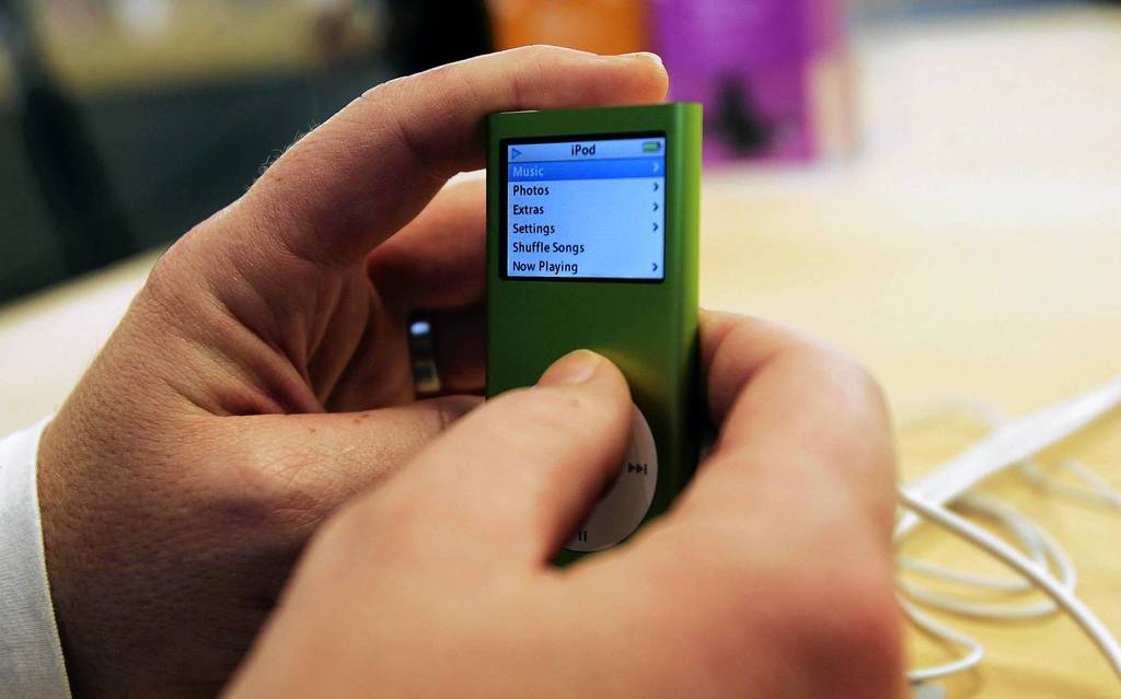 A consumer examines a just-released iPod nano at the Apple Store on Fifth Avenue in New York. The update on the popular music player sports a thinner design, five colors, a new search function and longer battery life.