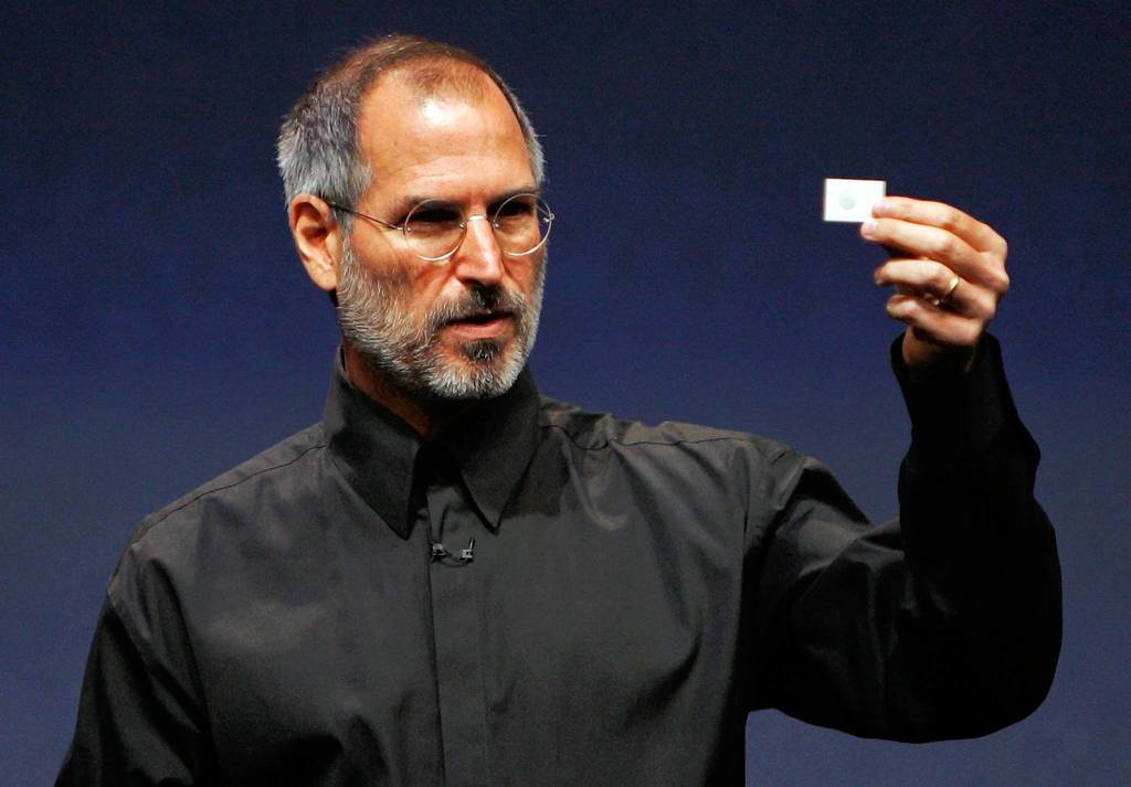 Apple CEO Steve Jobs holds up a new iPod Shuffle as he delivers a keynote address during an Apple media event in San Francisco.