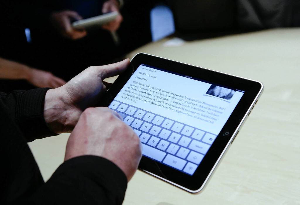 Event guests play with the Apple iPad I during an Apple Special Event at Yerba Buena Center in San Francisco.