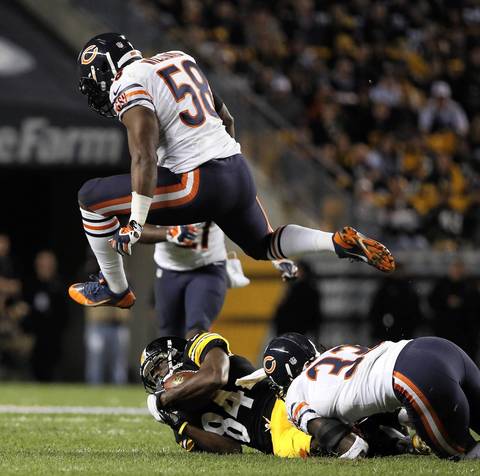 Chicago Bears middle linebacker D.J. Williams (58) leaps over Pittsburgh Steelers wide receiver Antonio Brown (84) in the second quarter.