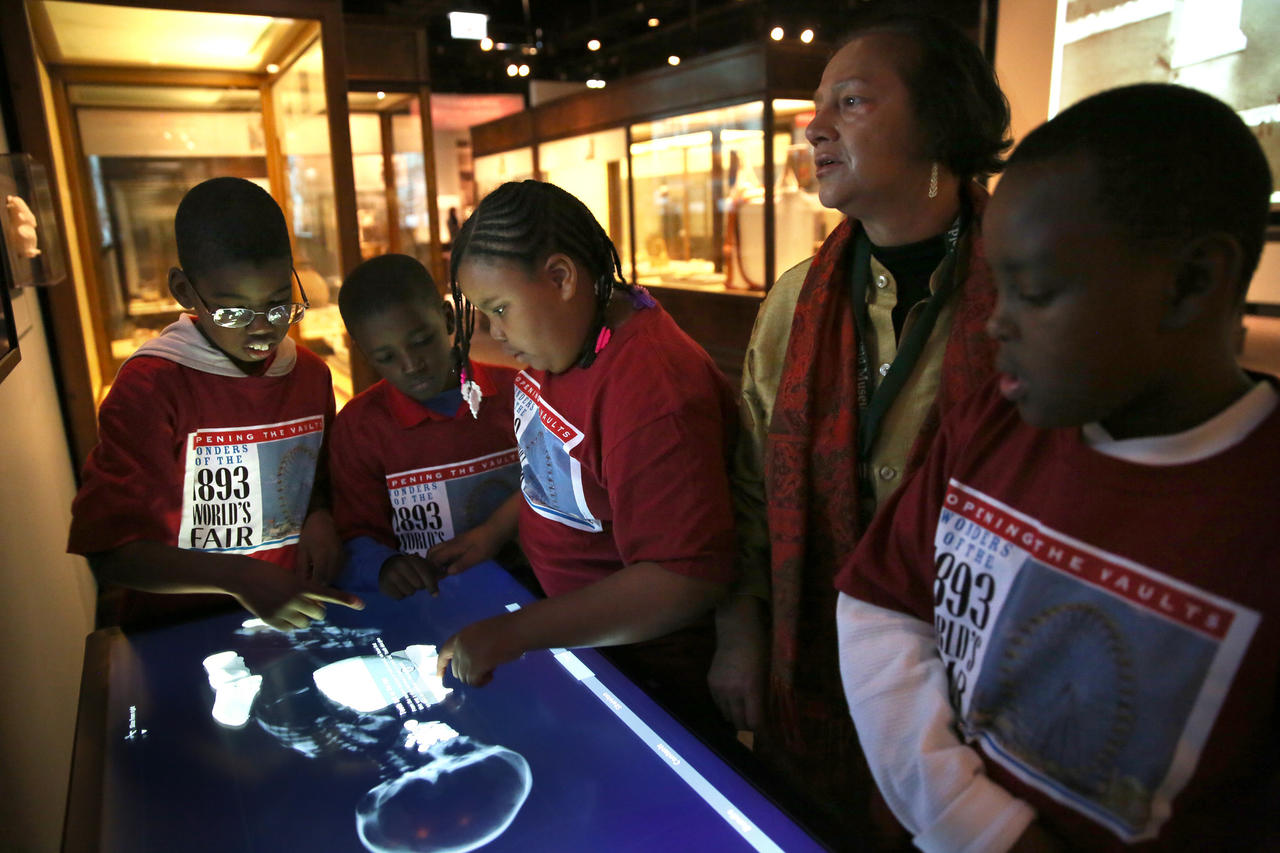 Students from Leif Ericson Elementary Scholastic Academy with Field Museum Anthropolgist Alaka Wali, look at an exhibit on a Peruvian mummy.