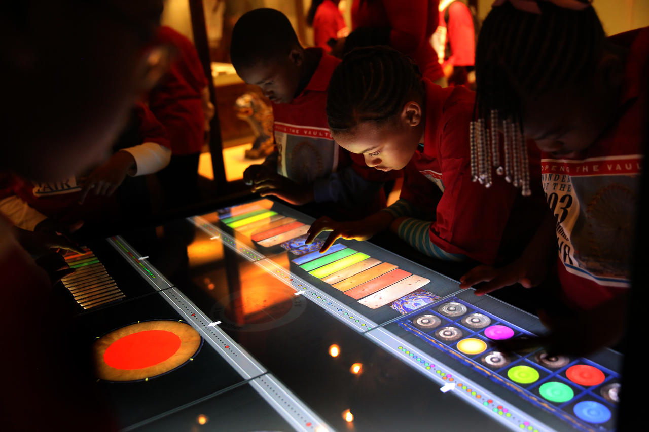 Students from Leif Ericson Elementary Scholastic Academy play an interactive electronic gamelon on that is part of an exhibit featuring different instruments that make up a gamelon from Indonesia that was on display the World's Fair.