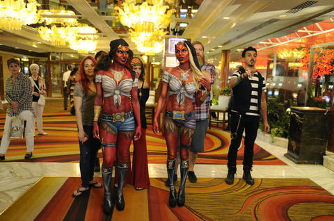Kelly "Red" Belmonte (from left), Heather Aguilera, Drew Maverick and Nicholas "Nix" Herrera walk behind models in their paint. The devilish pirates will appear in the video for The James Douglas Show's new song "Vegas Hot," which will premiere Nov. 5 when the "Naked Vegas" episode airs.