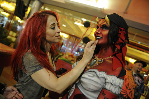 Kelly "Red" Belmonte applies paint to a model. The devilish pirate will appear in the video for The James Douglas Show's new song "Vegas Hot," which will premiere Nov. 5 when the "Naked Vegas" episode airs.