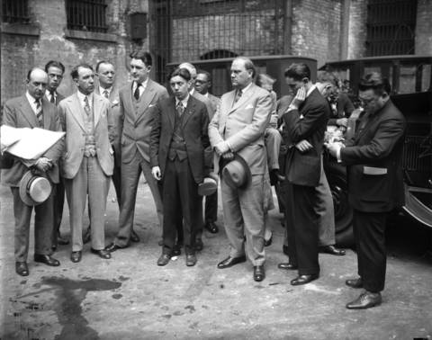 Eugene McGarry, a Durkin attorney, Martin Durkin (5th from left), Roland Libonati, another Durkin attorney, Judge Harry B. Miller, and Mike Romano, Assistant State's Attorney, circa July 6, 1926, at Porter Brother's Garage at 6231 Princeton Avenue. Lee Porter showed the court the bullet holes from when Martin Durkin shot and killed FBI Agent Edwin Shanahan.