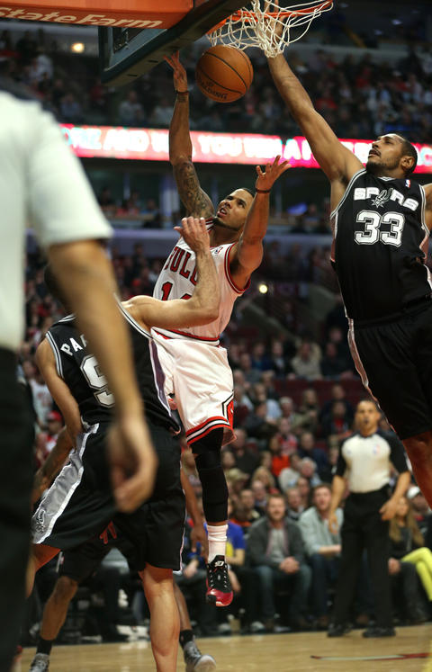 D.J. Augustin has his layup blocked by the Spurs' Boris Diaw in the first half.