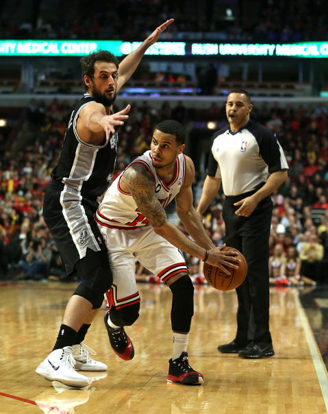D.J. Augustin is pressured by the Spurs' Marco Belinelli in the first half.