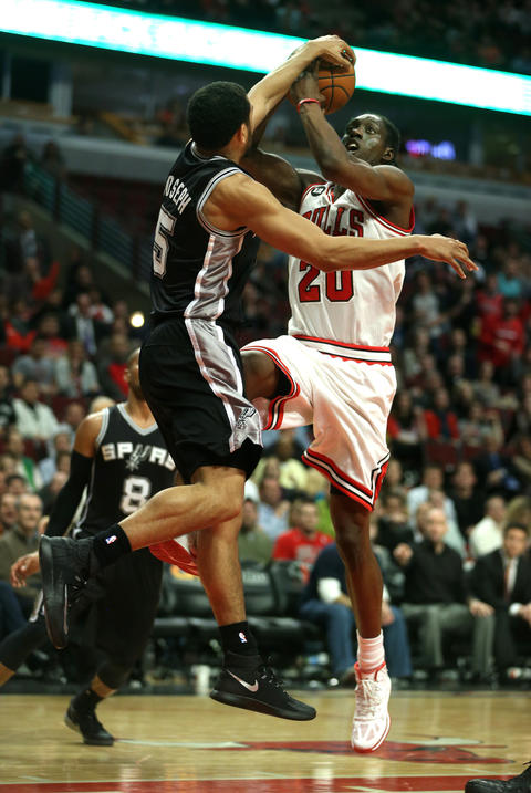 Tony Snell has his layup attempt blocked by the Spurs' Cory Joseph in the fourth quarter.