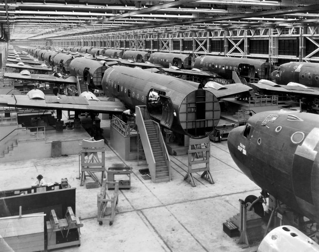 The assembly line in the Douglas Aircraft plant in Park Ridge, Ill., where wings are attached to the fuselage of big C-54 cargo planes. The plant was 15 percent ahead of schedule in June 1944.