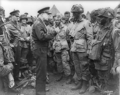 Allied forces Supreme Commander General Dwight D. Eisenhower speaks with U.S. Army paratroopers of Easy Company, 502nd Parachute Infantry Regiment (Strike) of the 101st Airborne Division, at Greenham Common Airfield in England June 5, 1944.
