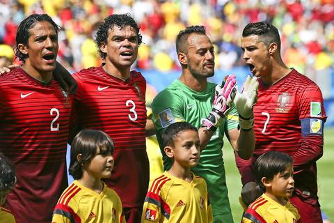 Portugal's Bruno Alves, from left, Pepe, Beto and Cristiano Ronaldo sing the national anthem before the FIFA World Cup 2014 group G preliminary round match between Portugal and Ghana at the Estadio Nacional in Brasilia.