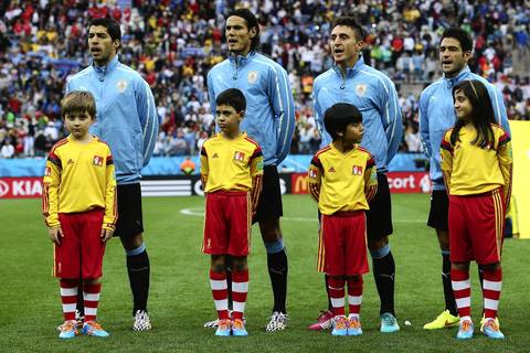 Luis Suarez, from left, Edinson Cavani, Cristian Rodriguez and Nicolas Lodeiro of Uruguay sing the National Anthem before the 2014 FIFA World Cup Brazil Group D match between Uruguay and England at Arena de Sao Paulo.