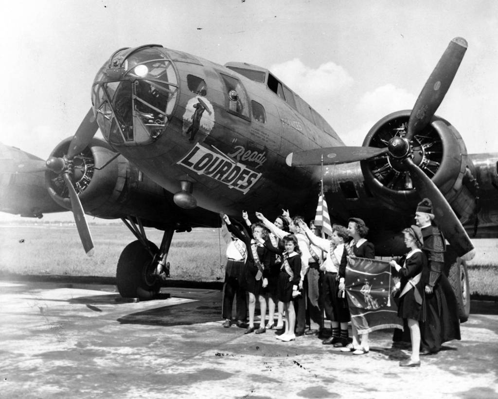 A B-17 bomber purported to have been paid for with their war bonds is christened by children of Our Lady of Lourdes parochial school, located at Ashland and Leland Avenues in Chicago, in June 1944. According to the caption on this archive image,