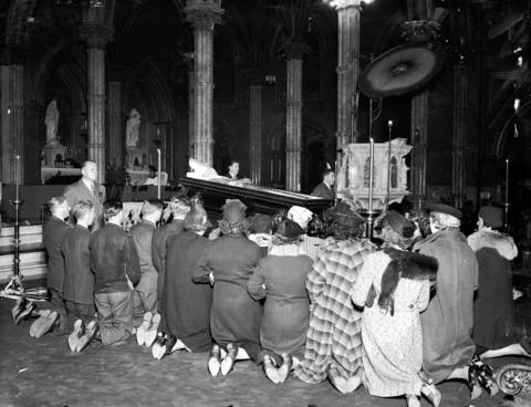 People gather to pray over the body of Cardinal Mundelein inside Holy Name Cathedral in Oct. of 1939. Mundelein's body lay in state for several days before he was interred at St. Mary of the Lake Seminary in Mundelein, Ill.