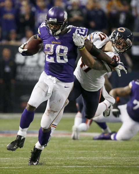 Minnesota Vikings running back Adrian Peterson drags Bears safety Chris Conte for extra yards during overtime of a game in Minneapolis on Dec. 1.
