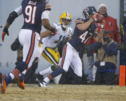 Chris Conte intercepts Green Bay quarterback Aaron Rodgers' pass during the first quarter of the regular-season finale at Soldier Field on Dec. 29.