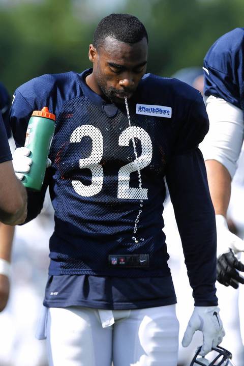 Bears running back Michael Ford spits out water at training camp.