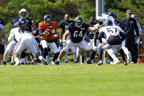 Bears quarterback Jay Cutler and the offense work against the defense.