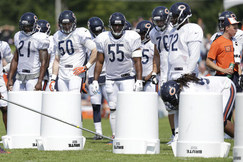 Ryan Mundy (21), Shea McClellin (50), Lance Briggs (55) and others watch during special teams drills.